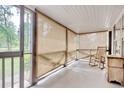 Relaxing screened porch featuring neutral curtains, wood accents, and a comfortable rocking chair at 2206 Beck St., Georgetown, SC 29440