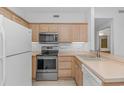 Bright kitchen featuring wooden cabinets and modern appliances at 2312 Sweetwater Blvd. # 2312, Murrells Inlet, SC 29576
