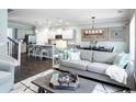 Open concept living room featuring hardwood floors, decor, and modern lighting at 2425 Watershed Way, Longs, SC 29568