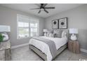 Cozy bedroom featuring a comfortable bed, modern decor, and a ceiling fan for added comfort at 2517 Watershed Way, Longs, SC 29568
