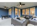 Inviting outdoor patio area complete with comfortable seating, ceiling fans, and ample space for entertaining at 2517 Watershed Way, Longs, SC 29568