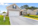 Well-maintained home displaying a spacious driveway, neat lawn, and a two-car garage at 263 Lakota Loop, Longs, SC 29568