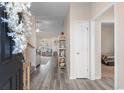 Inviting entryway with wood floors leading into a living area, showcasing modern shelving at 263 Lakota Loop, Longs, SC 29568