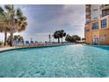 Beautiful outdoor pool area with lounge chairs and palm trees at 2710 N Ocean Blvd. # 804, Myrtle Beach, SC 29577