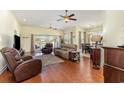 Open concept living room featuring hardwood floors, ceiling fans, and lake views at 2940 Tigers Eye Rd., Little River, SC 29566
