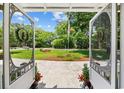 View of front yard, garden, and flagpole seen through decorative screen doors at 4023 Murrells Inlet Rd., Murrells Inlet, SC 29576