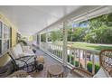 Relaxing screened-in porch featuring wicker furniture and an inviting outdoor ambiance at 4023 Murrells Inlet Rd., Murrells Inlet, SC 29576