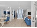 Bright, open-concept living room with sleek floors and blue accents; perfect for entertaining guests at 4206 S Ocean Blvd., North Myrtle Beach, SC 29582