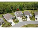 An aerial view showcases the property's location in a lush, green neighborhood with mature trees at 4246 Livorn Loop, Myrtle Beach, SC 29579