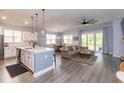Open-concept living area with modern decor, lots of light, and a kitchen island at 428 Calhoun Falls Dr., Myrtle Beach, SC 29579