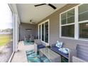 Inviting screened porch with ceiling fans, seating, and view of backyard at 428 Calhoun Falls Dr., Myrtle Beach, SC 29579