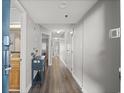 Hallway features wood flooring, neutral paint, and tasteful decorations in condo at 4800 S Ocean Blvd. # 420, North Myrtle Beach, SC 29582