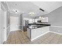 Well-appointed kitchen featuring white cabinets, stainless steel appliances, granite countertops, and breakfast bar at 4860 Carnation Circle # 302, Myrtle Beach, SC 29577