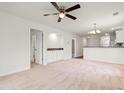 Open-concept living room with neutral carpet, ceiling fan, and view into kitchen area at 545 White River Dr. # 15 D, Myrtle Beach, SC 29579