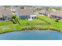 Aerial view of a home with a black metal fenced backyard, and water view with lovely landscaping at 567 Hickman St., Myrtle Beach, SC 29575