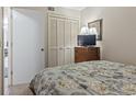 Cozy bedroom featuring closet, mirror, and floral bedding in a comfortable space at 5905 South Kings Hwy. # 131B, Myrtle Beach, SC 29575