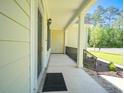 Inviting front porch features a covered entrance, decorative railings, and space for seating at 625 Whispering Pines Ct., Murrells Inlet, SC 29576