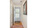 Hallway with light beige walls, a white paneled door, and light wood flooring with a patterned rug at 665 Tupelo Ln. # 17-F, Longs, SC 29568
