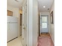 Hallway with white walls and trim, showing entry, kitchen, and laundry closet at 665 Tupelo Ln. # 17-F, Longs, SC 29568