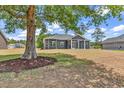 Large backyard featuring a screened-in porch and mature trees at 722 Highway 348, Loris, SC 29569