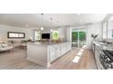 Open-concept kitchen featuring granite counters, a large island with seating, and stainless steel appliances at 723 Rupert Dr, Conway, SC 29526