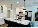 Modern kitchen with white cabinets, stainless steel appliances, and a stylish marble countertop island at 801 Talbot Circle, Myrtle Beach, SC 29577