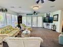 Bright sunroom filled with natural light features plush seating, a ceiling fan, and a view to the yard at 801 Talbot Circle, Myrtle Beach, SC 29577