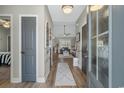 View of the light-filled foyer showcasing hardwood floors and an open floor plan at 804 Twickenham Loop, Longs, SC 29568