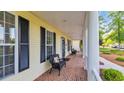 Spacious front porch with brick flooring, white columns, and plenty of room for seating at 813 Bear Lake Dr., Longs, SC 29568
