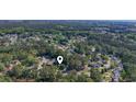 Wide aerial shot of a home surrounded by mature trees in a quiet neighborhood at 88 Purple Martin Dr., Murrells Inlet, SC 29576