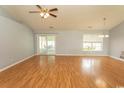 Spacious living room with hardwood floors, ceiling fan, and sliding glass doors to the back porch at 908 Hornbeam Ct., Loris, SC 29569