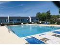 Large community pool with ample seating and lounge chairs, perfect for relaxation and summer fun at 913 Villa Dr. # 913, North Myrtle Beach, SC 29582