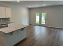 A well lit living room with doors to a fenced backyard at 945 Laconic Dr., Myrtle Beach, SC 29588