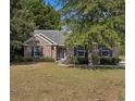 Charming single-story brick home with shuttered windows and a well-manicured front yard at 101 Alpharetta Ct., Conway, SC 29526