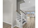 Staircase with wood treads, white risers and decorative balusters leading to the upper level at 1055 Laconic Dr., Myrtle Beach, SC 29588