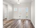 Bright foyer featuring hardwood floors and a white door with glass sidelights and transom at 109 Old Chimney Ln, Conway, SC 29526