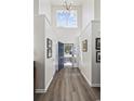 Bright foyer features hardwood floors, high ceilings, and a decorative light fixture at 1127 Harvester Circle # 1127, Myrtle Beach, SC 29579