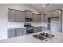 Close up of kitchen features modern stainless steel appliances and stylish gray cabinetry at 115 Old Chimney Ln, Conway, SC 29526