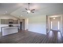 Open floor plan featuring spacious living area with wood floors, leading into the kitchen at 115 Old Chimney Ln, Conway, SC 29526
