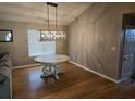 Dining room features wood floors, decorative light fixture and round table at 117 Wagon Wheel Ln., Surfside Beach, SC 29575