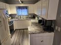 Modern kitchen featuring white cabinets, granite countertops and stainless steel appliances at 117 Wagon Wheel Ln., Surfside Beach, SC 29575