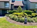 Landscaped community entrance with lush green bushes and a view of the stilt-supported homes at 124 Spartina Ct. # 30, Pawleys Island, SC 29585