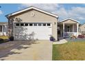 Spacious two-car garage with a concrete driveway and well-manicured lawn at 133 Lakeside Crossing Dr., Conway, SC 29526