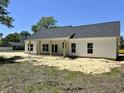 The house's rear exterior showcases a covered patio, large windows and clean design at 133 Thrush Ct., Georgetown, SC 29440
