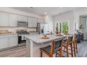 Modern kitchen with gray cabinets, stainless appliances, and a granite-topped island at 1406 Nokota Dr., Conway, SC 29526
