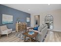 Cozy living room with modern decor, blue accent wall, stylish furniture and ample natural light at 1513 Seachase Way, North Myrtle Beach, SC 29582