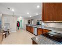 Open kitchen with stainless steel appliances, granite counters, and adjacent breakfast area at 189 Sea Turtle Dr., Myrtle Beach, SC 29588