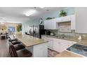 Spacious kitchen with granite counters, stainless steel appliances, and bar seating at 200 53Rd Ave. N # 409, North Myrtle Beach, SC 29582