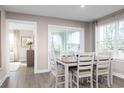 Bright dining area with wood floors, large window, and sliding glass doors to a patio at 2083 Nw Parow Ln Nw # B, Calabash, NC 28467