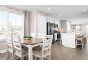 Open concept dining and kitchen area with stainless steel appliances and a breakfast bar at 2083 Nw Parow Ln Nw # B, Calabash, NC 28467